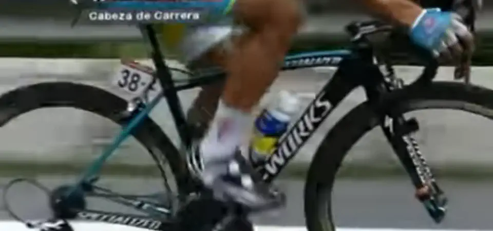 Paolo Tiralongo (Astana), a former teammate of Alberto Contador (Saxo-Tinkoff), carrying Contador's water bottle during stage 17 of Vuelta a España 2012.