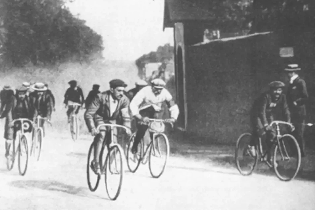 Maurice Garin, in his trademark white coat and flat cap during a stage at the 1903 Tour, the first edition. He became the first winner of the Tour de France.