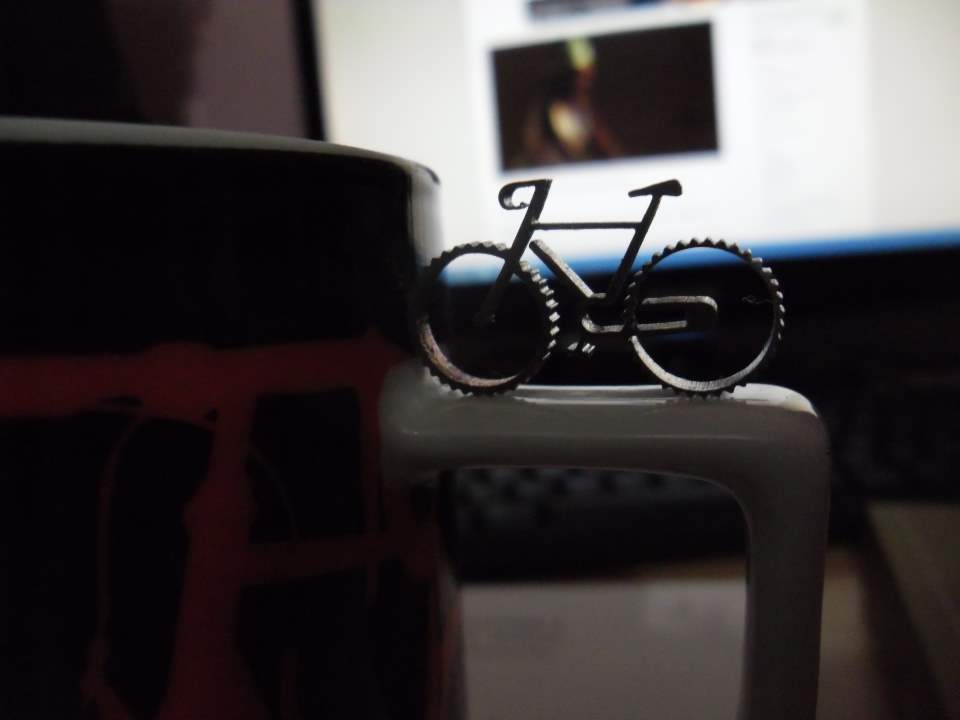 A micro bicycle and a mug