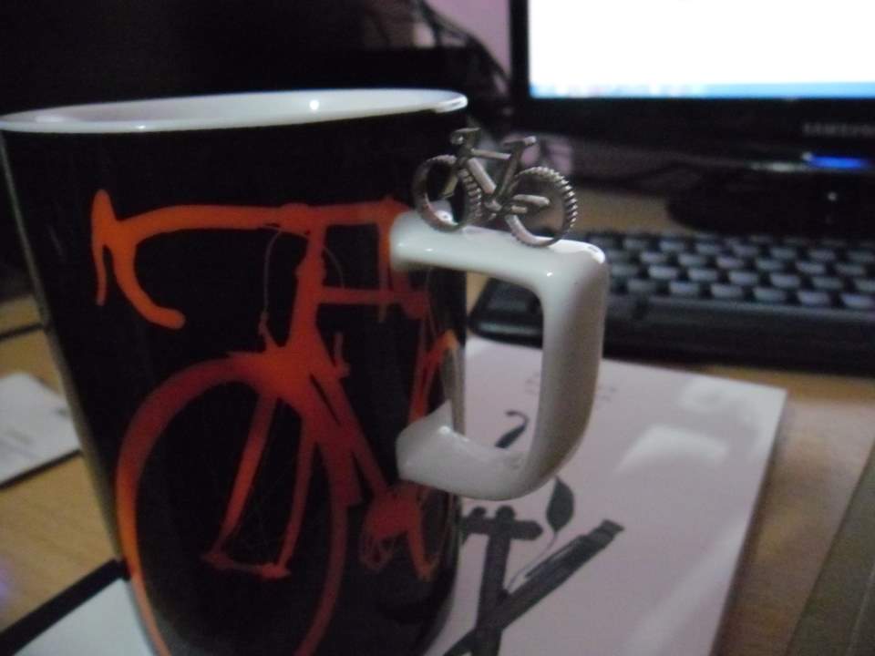 A micro bicycle and a mug with a bicycle image