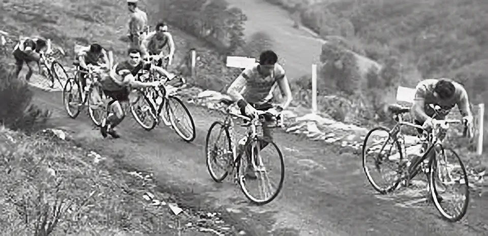 Cyclists climbing Muro di Sormano, on foot.