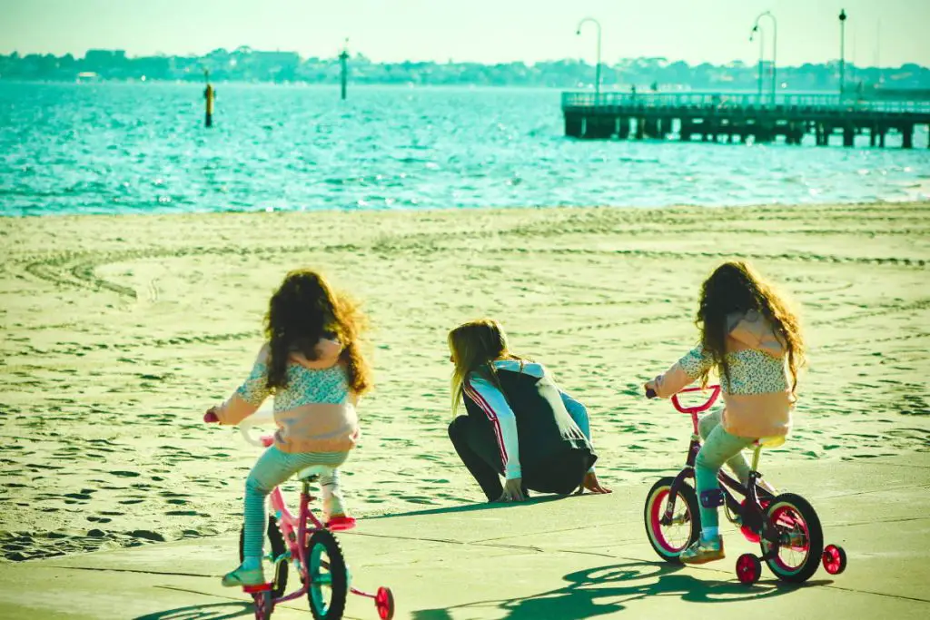 Helping Children With Autism Develop Cycling Skills - two girls riding bicycle