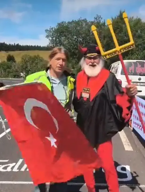 Ahmet Mumcu - the man who waves the Turkish flag at the Tour de France stage finishes, with Didi Senft during the Tour de France 2025